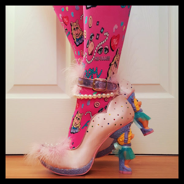 side view Miss Piggy All About Moi side view showing jewel detail and glitter platform with character heel on All About Moi