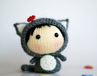 http://www.ravelry.com/patterns/library/gray-girl-cat--knitted-round--toy-from-the-tanoshi-series