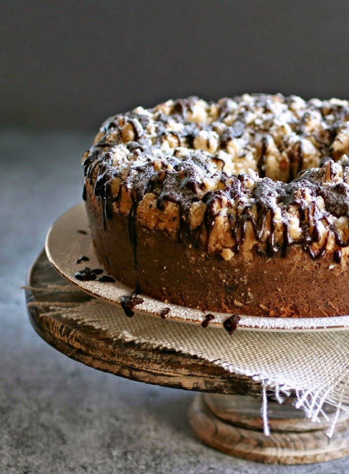 Recipe for a moist chocolate chip cake with a thick crumb topping and chocolate sauce.