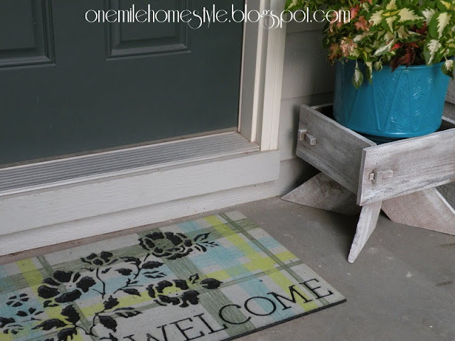 Painted planter box and flower pot with new welcome mat