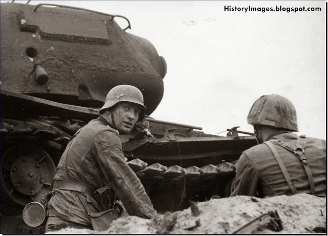 German soldiers take cover against  destroyed Soviet KV-1 tank  Lake Ladoga Leningrad September 15 1943