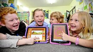 Children playing learning games on their iPads