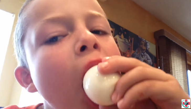 Kid eating a hard-boiled egg