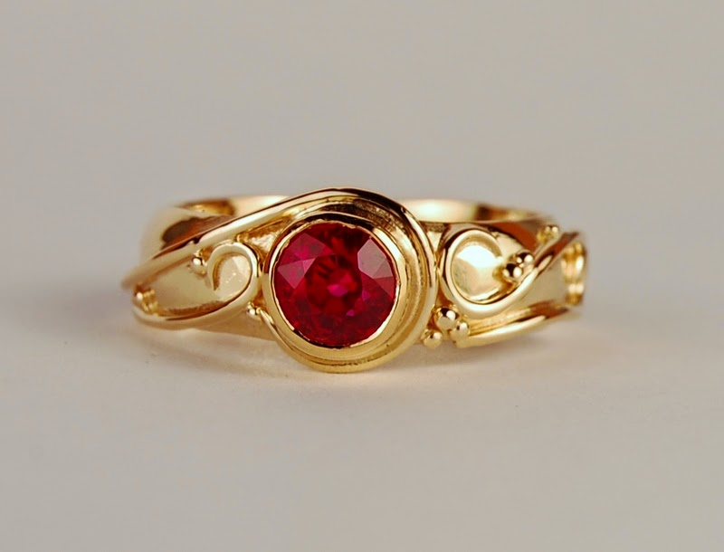 18k yellow gold and 1.11 ct. ruby ring Round red stone set in yellow gold ring with swirls of wire