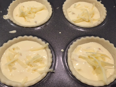 Mini Cheese and Onion Quiche mixture in the pastry cases- close up