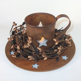 http://www.outerbankscountrystore.com/primitive-tealight-candle-holder-set-rusty-w-black-tan-berry-ring/