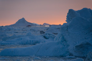 Sun setting behind the icebergs
