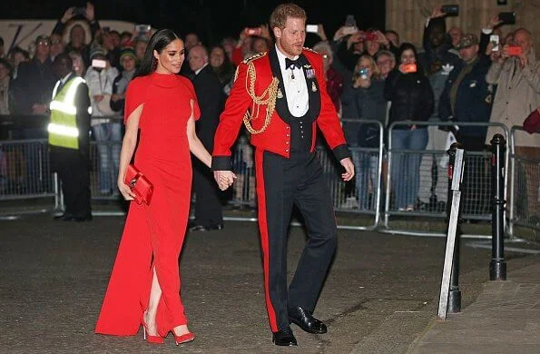 Meghan Markle wore Safiyaa Kalika dress, Stuart Weitzman Nouveau pumps, Simone Rocha earrings, Manolo Blahnik clutch bag