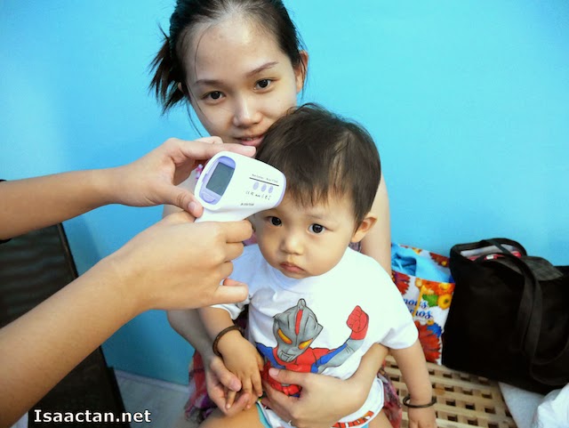 Baby Martin having his temperature taken prior to the swimming session