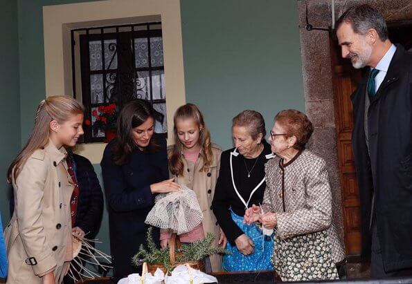 Crown Princess Leonor and Infanta Sofia wore Carolina Herrera trench coat, Mango Prince of Wales trousers. Queen Letizia