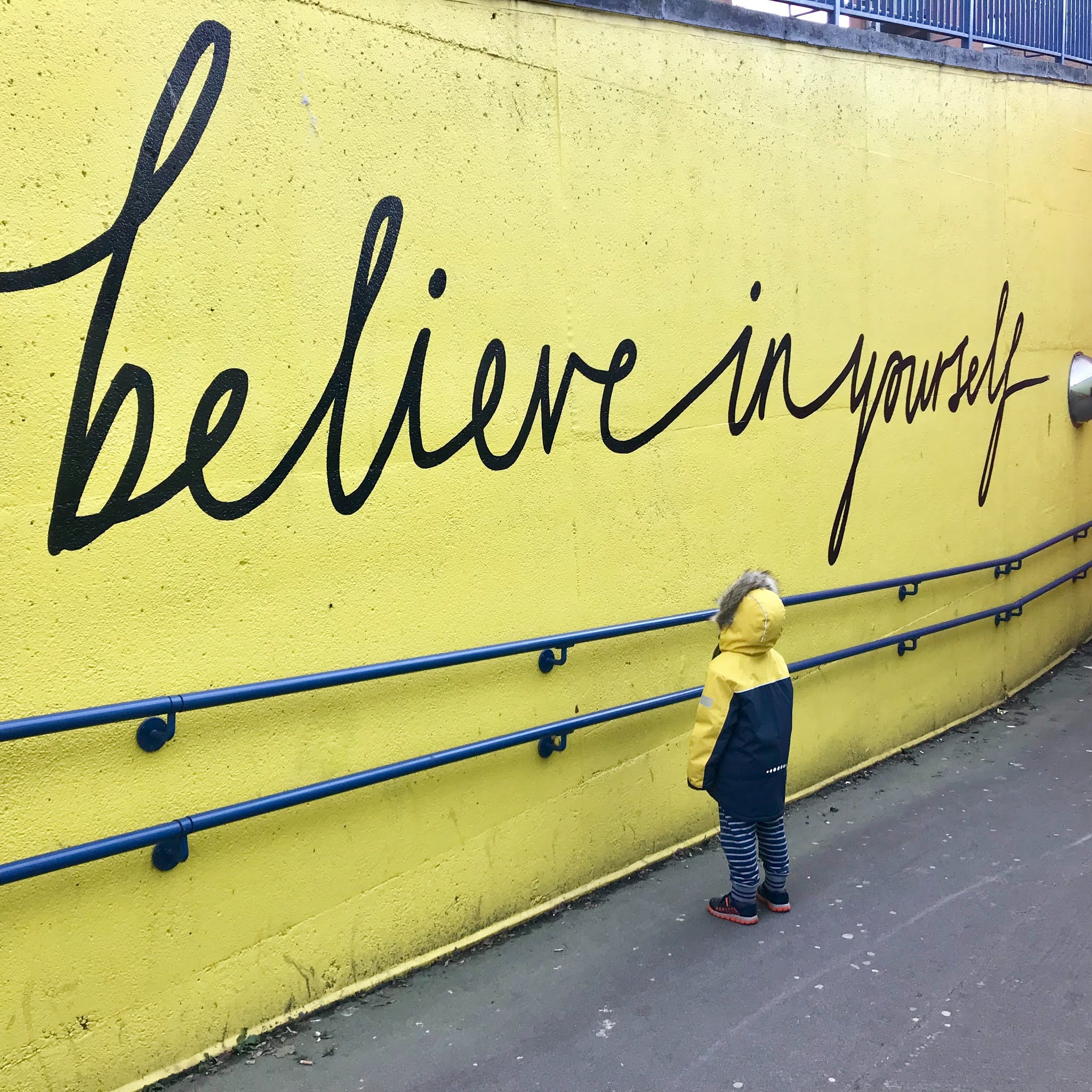 'believe' graffiti on a yellow wall