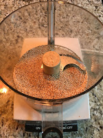 Sesame seeds to make tahini. https://trimazing.com/ Photo of 1 cup of raw sesame seeds in a food processor bowl. https://trimazing.com/