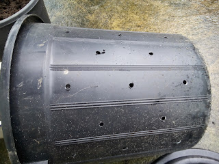 Drilled holes around the bin