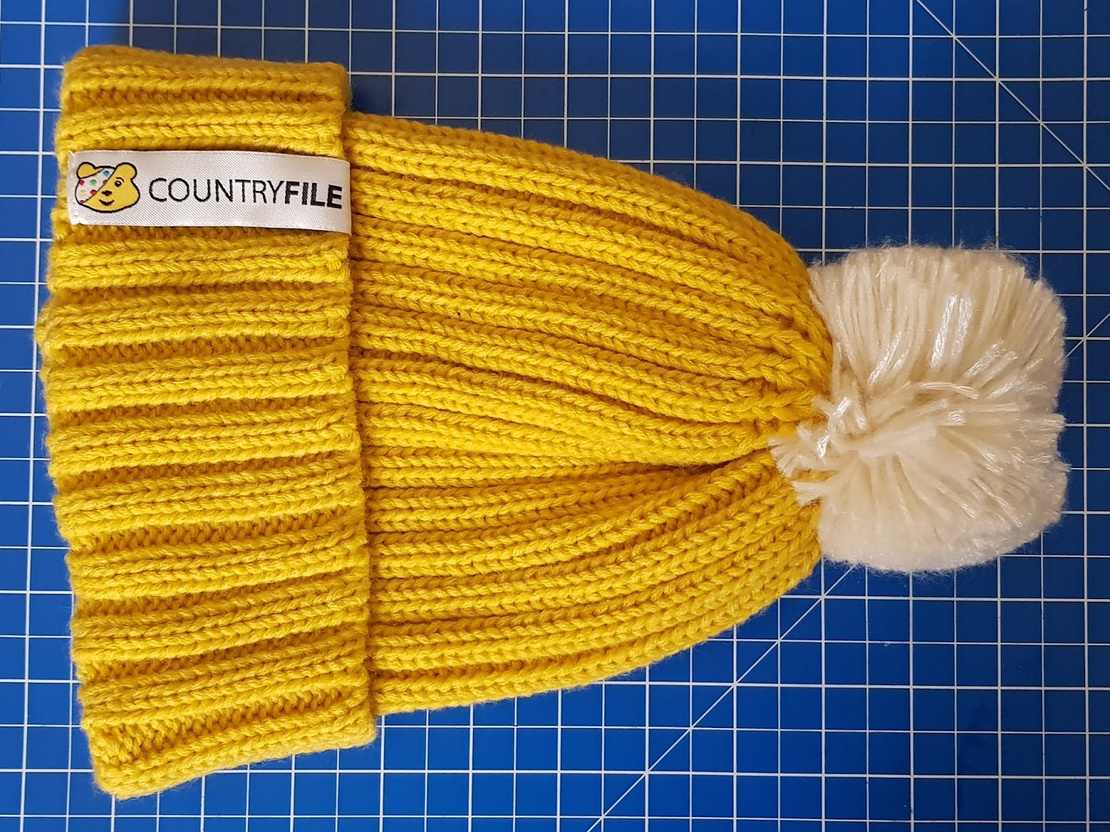 black and yellow bobble hat