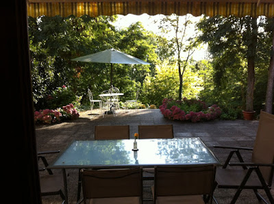 Terrace of self catering barn conversion to rent in Loire Valley looking on to terrace and river of vacation rental in Loire Valley