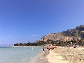 Mondello's beautiful sandy beach is largely free to use and attracts crowds of bathers in high season