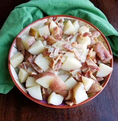 German potato salad served warm with plenty of bacon and a zingy vinaigrette is the perfect side dish to so many meals. It is simple to make too! german potato salad with bacon and onion vinaigrette