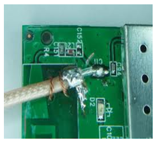A brute-force method of gaining access to a  signal: cutting a trace and soldering coax to a PCB