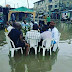 Checkout This Viral Pictures Of Men Drinking Beer In Lagos Flood - OMG