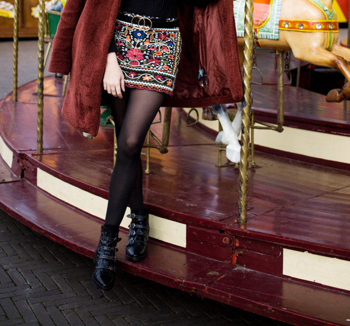 rust coloured teddy coat, embroidered skirt, buckle boots