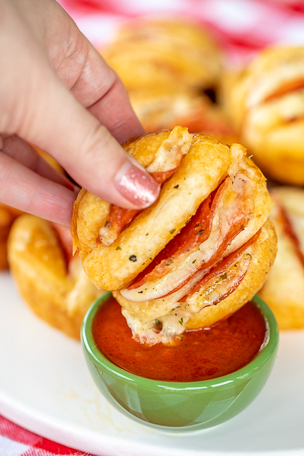 Hasselback Pizza Biscuits - a fun twist to pizza night!!! Refrigerated biscuits stuffed pepperoni and cheese and brushed with garlic butter. Dip in warm pizza sauce. SO good! Great for parties, lunch, dinner, or afternoon snack. SO easy to make and everyone LOVES them!! #pizza #pepperoni Hasselback Pizza Biscuits - a fun twist to pizza night!!! Refrigerated biscuits stuffed pepperoni and cheese and brushed with garlic butter. Dip in warm pizza sauce. SO good! Great for parties, lunch, dinner, or afternoon snack. SO easy to make and everyone LOVES them!! #pizza #pepperoni