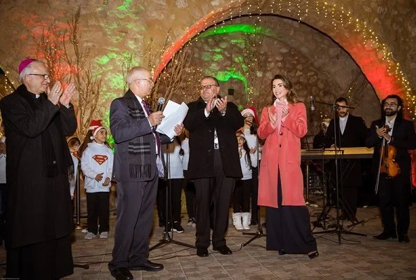 Queen Rania wore wool cashmere coat in coral pink. Christmas tree lighting ceremony at Qanater Ampitheatre in Fuheis