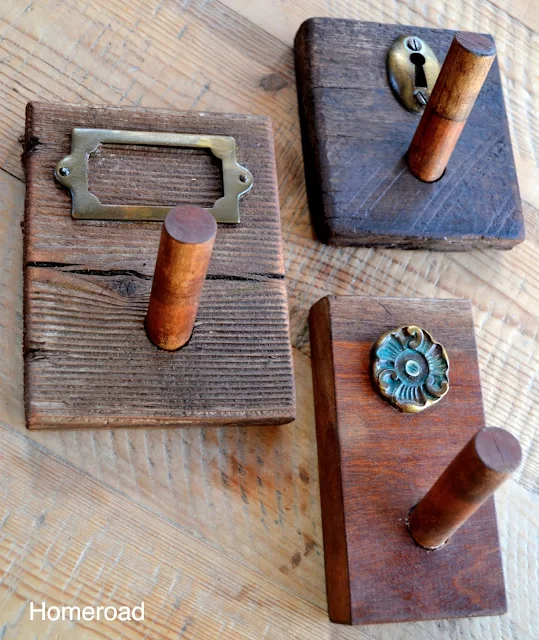 Set of rustic distressed peg hooks with brass accents. 