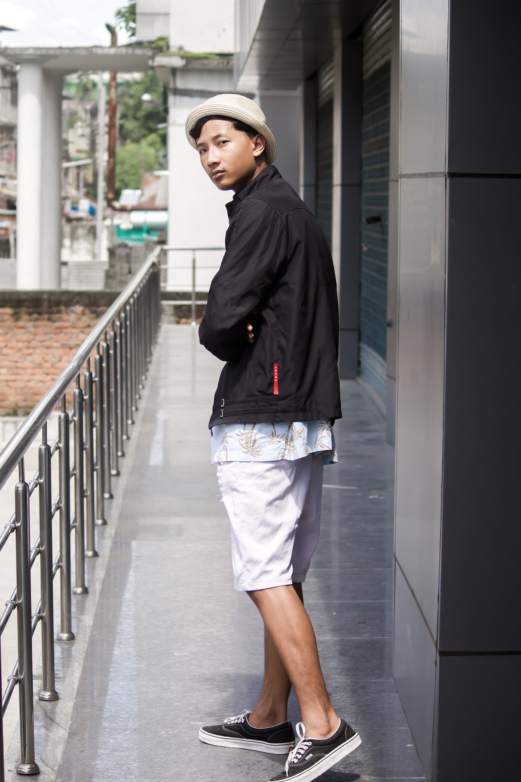 TheQuirkyMinimal by Kangkan Rabha for Farfetch Apple Music partnership wearing Vintage Prada jacket, Old Navy Printed shirt, Thrifted DIY pants, Black Vans via Jabong, Levis Hat