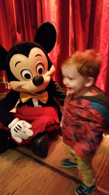 Toddler meeting Mickey Mouse