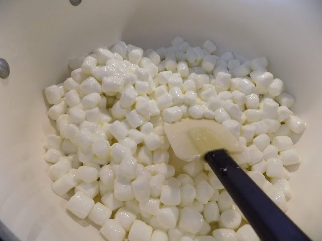 A picture of marshmallows being blended in a pot of melted butter