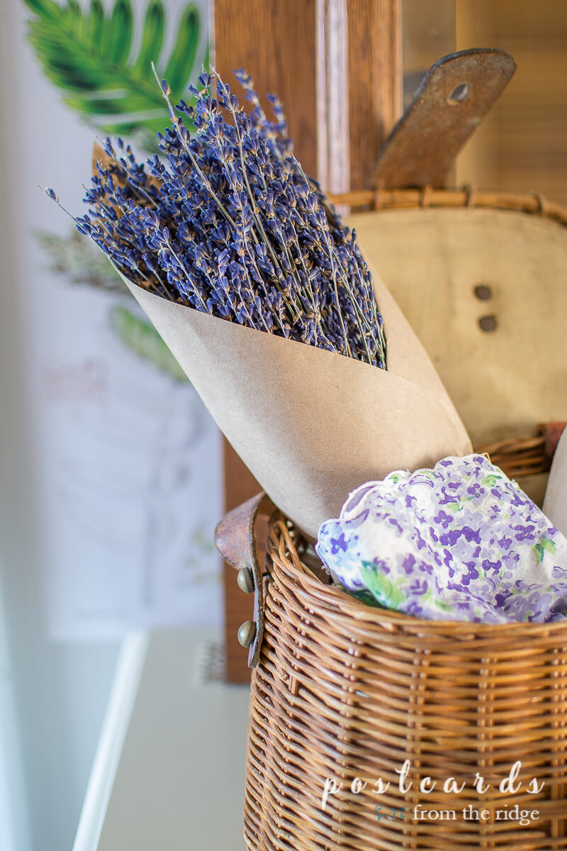 dried lavender and vintage linens in fishing creel basket