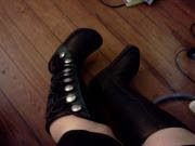 A picture of my knee-high Renaissance boots, black with green trim and silver buttons