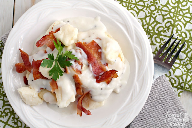 Moist & fluffy potato biscuits are topped with cheese curds, a homemade bacon gravy, and crispy bacon in this Potato Biscuits & Bacon Gravy Poutine.