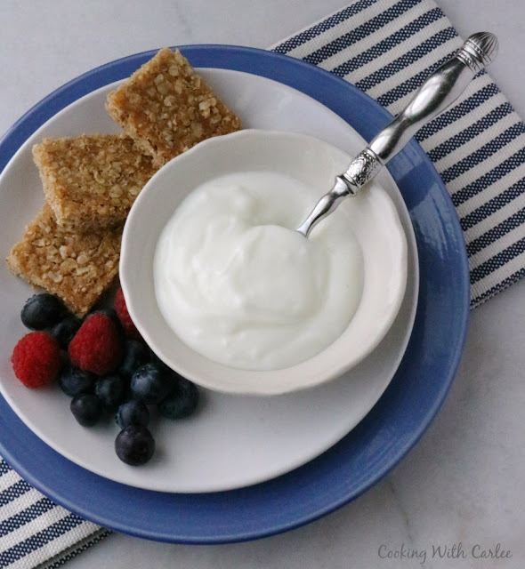 Perfectly easy to make oatmeal bars that are kissed with brown sugar are a great grab and go breakfast or fun homemade snack. brown sugar oatmeal squares with bowl of yogurt and fresh fruit