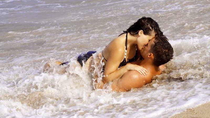 Romantic Love Couple Kissing in the Sea Tide
