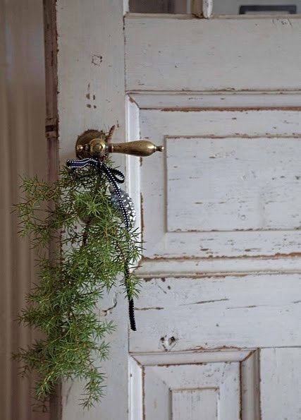 image Christmas greenery on vintage brass door lever #FrenchChristmas #vintagedoor