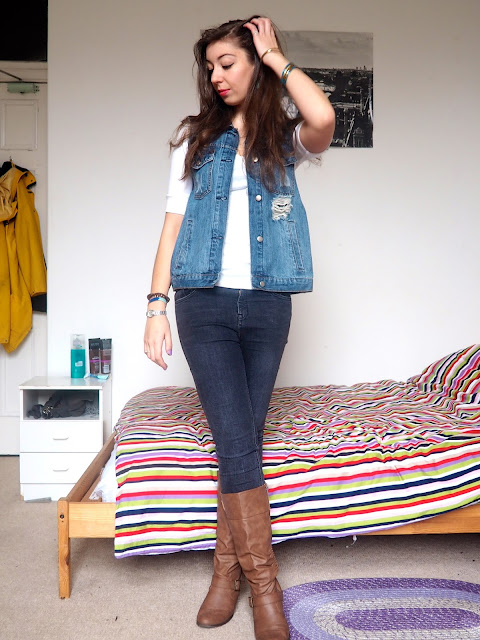 Flynn Rider Tangled Disneybound outfit - blue denim waistcoat, white top, grey skinny jeans and brown leather high heeled boots