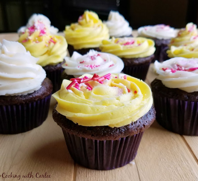 Adding a little "liquid gold" sweetened condensed milk to buttercream makes it feel extra special. It add that little bit of rich depth of flavor you can't get anywhere else! chocolate banana cupcakes with white and yellow sweetened condensed milk frosting and sprinkles