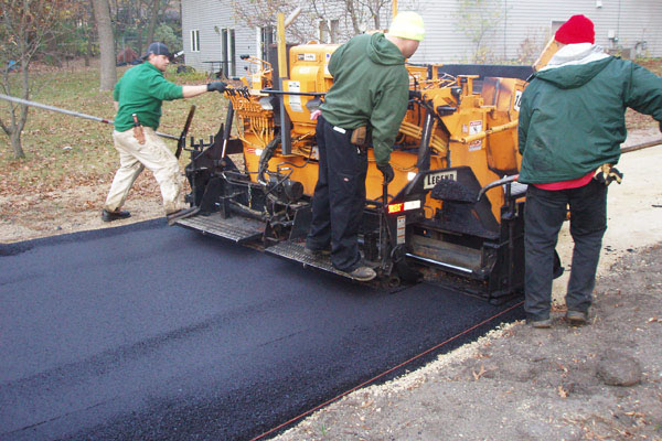 home improvement - asphalt driveway - construction workers