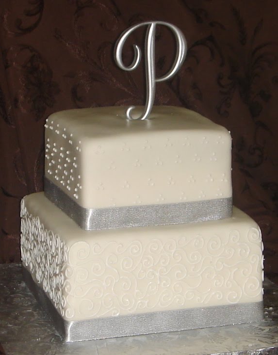 Two tier square white fondant wedding cake with swiss dots 