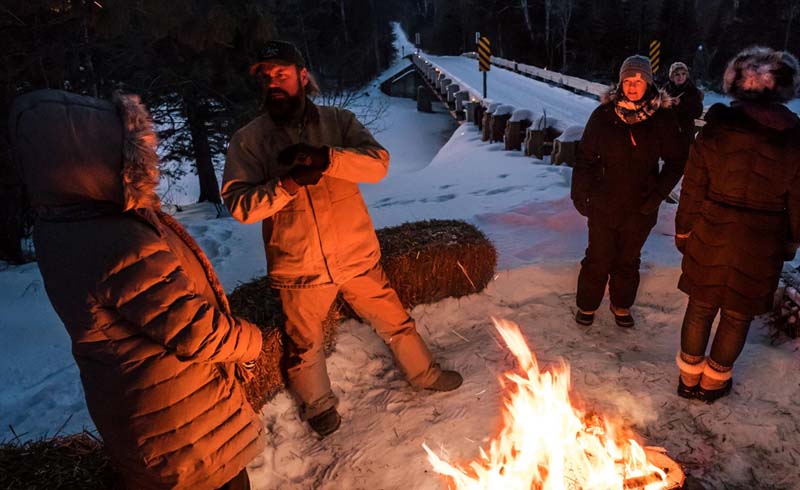 Volunteers warm up at the remote Sawbill Checkpoint.