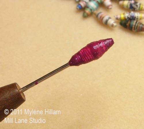 First coat of nail polish on a paper bead