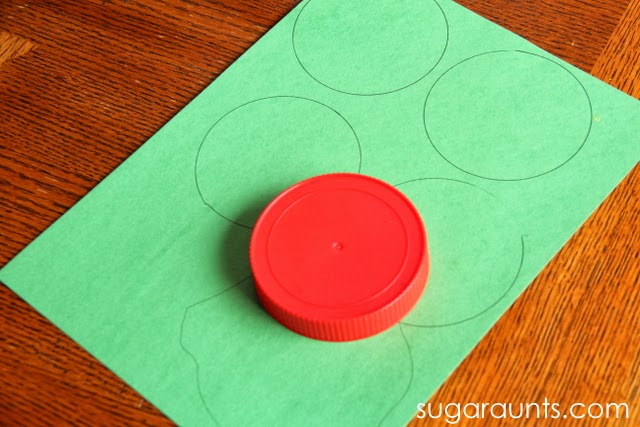 Construction paper for cherry blossom tree craft Trace a lid to make circles for cherry blossom tree craft.