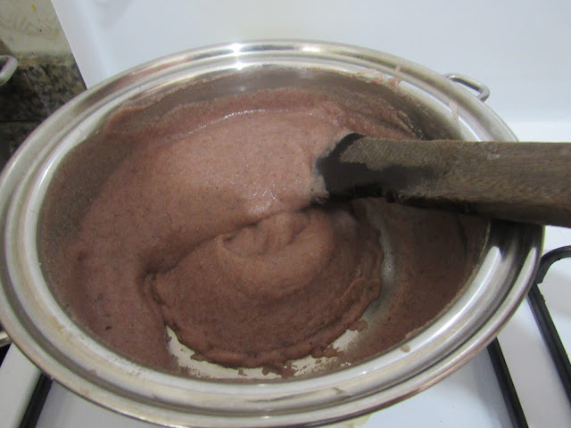 Continue to stir guinea corn flour as it boils on the cooker