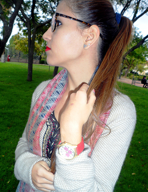 Maxi jersey asimétrico con vaqueros rasgados, botines burdeos, maxi bufanda y reloj