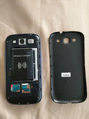 Wireless Charging Receiver Card Positioned in Place The wireless charging receiver card module, positioned and taped in place onto the battery.