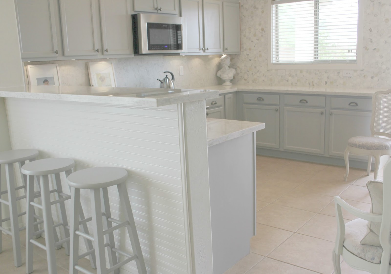 Serene Nordic French kitchen grey and white kitchen with marble statement wall and quartz countertop