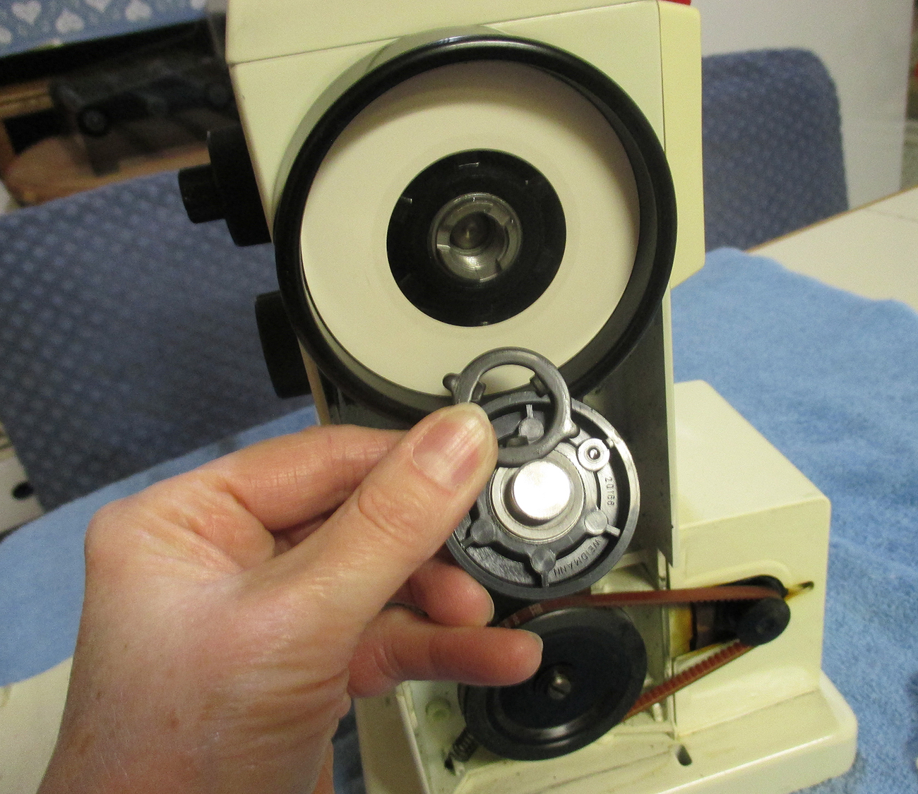 She's A Sewing Machine Mechanic Cleaning The Bobbin Winder Clutch on a