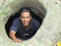My Tikal guide Abel Lucero, at Mayan storage hole near El Mundo Perdido
