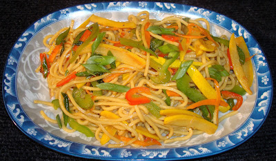LO MEIN NOODLES WITH OYSTER SAUCE AND VEGETABLES PORTIONS: 3 INGREDIENTS ½ lb. Lo Mein noodles 1 tbsp. sesame oil 2½ tbsp. oyster sauce  STIR FRY VEGETABLES 2 tbsp. vegetable oil 1 diced shallot 1 minced garlic clove 1 tsp. minced ginger 1 yellow squash skin cut in Julianne 2 carrots cut in Julianne ½ green pepper cut in Julianne ½ red pepper cut in Julianne 1/3 cup sliced scallions METHOD Cook Lo Mein noodles in boiling water al dente. Cool off with cold running water. Mix Lo Mein noodles with sesame oil and the oyster sauce. Heat up the oil in a frying pan and stir fry shallots, garlic and ginger together. Add and stir fry the vegetables. Add, mix and heat up the noodles with the vegetables. 